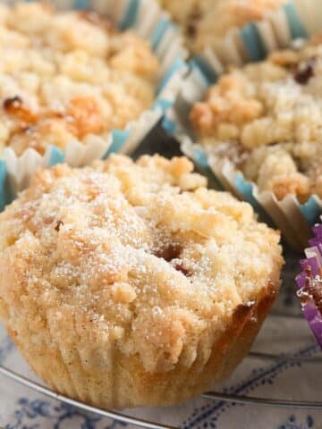 many small nectarine muffins with streusel on top.