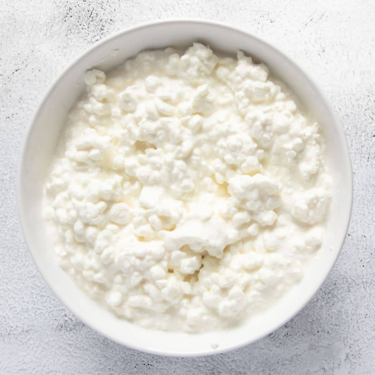 plain cottage cheese in a small white bowl.