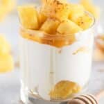 pinterest image with title of a glass with cottage cheese topped with pineapple.