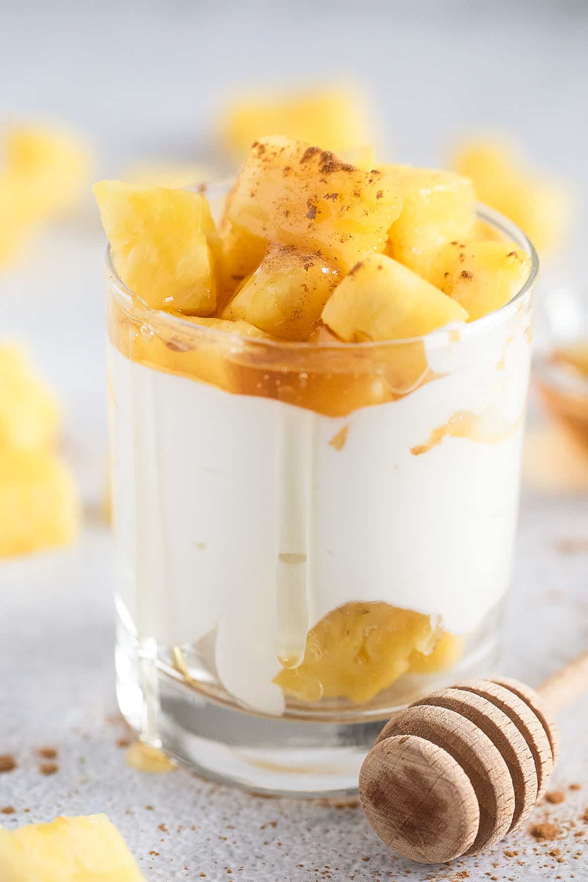 cottage cheese with pineapple drizzled with honey in a small jar.