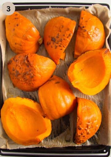 large, roasted pieces of pumpkin on a baking sheet.
