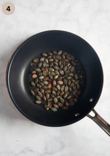 roasted pepitas in a small pan.