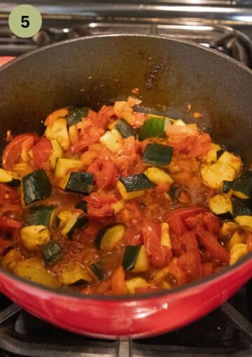 baked zucchini and tomato stew in a red dutch oven.