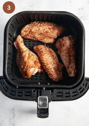 turkey wings in the air fryer basket before cooking.