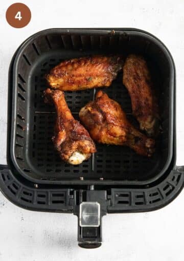 turkey wings in the air fryer basket after cooking.
