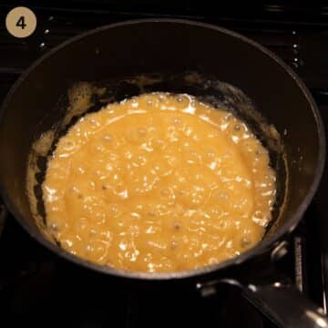 bubbling and thickened white sauce in a small pan.