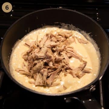 adding shredded turkey to creamy sauce.