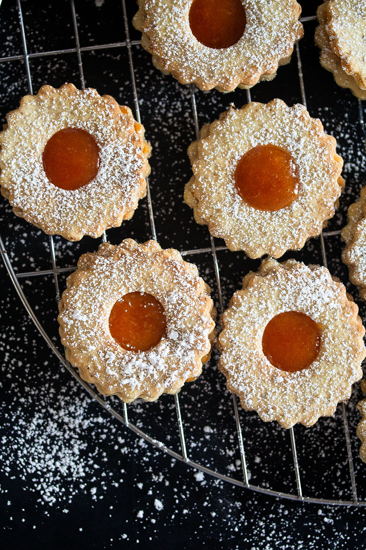 apricot jam cookies sprinkled with sugar on a wire rack.