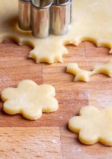cut out cookies on a brown board.