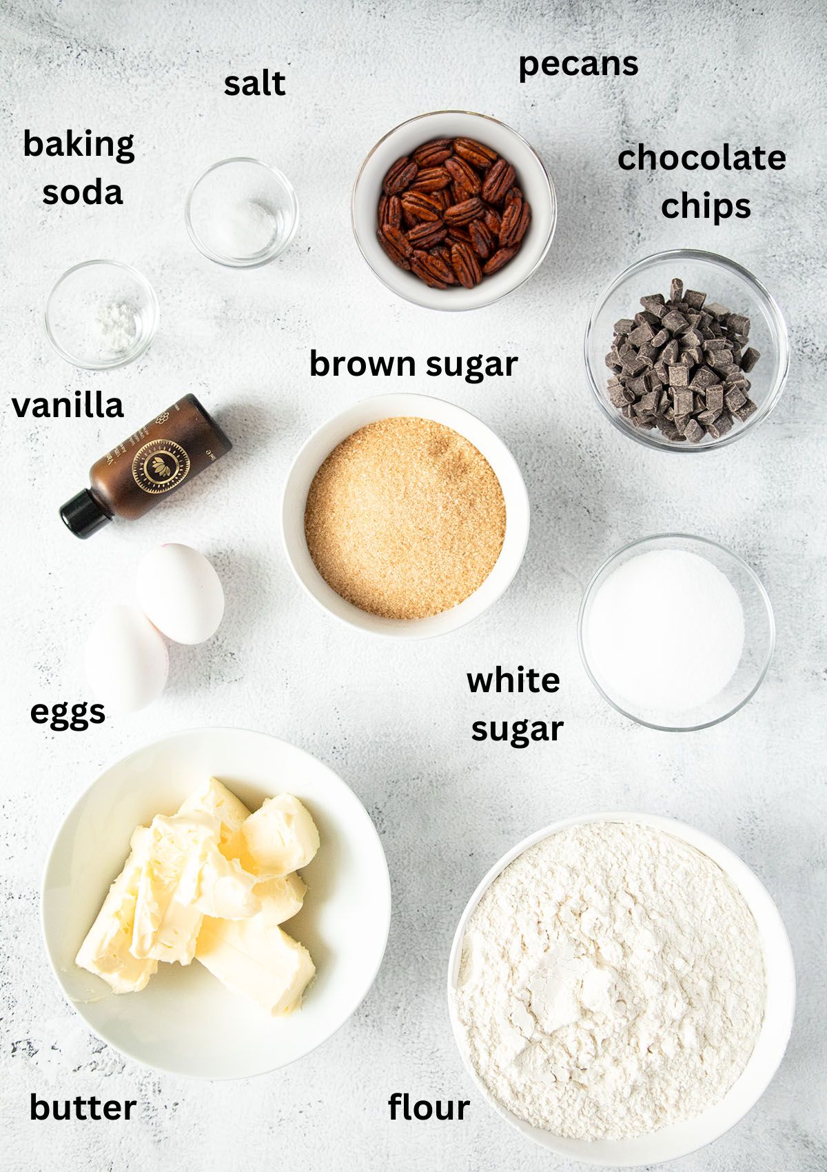 labeled ingredients for making cookies with chocolate chips and pecan nuts.