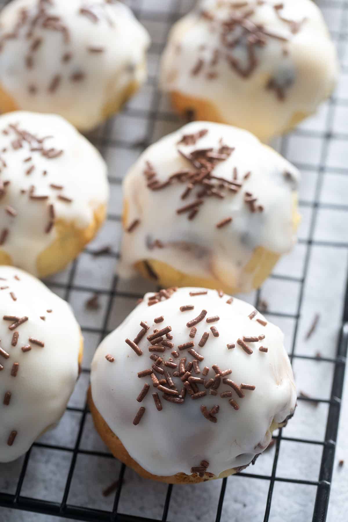 ricotta cookies with chocolate chips and orange glaze on a wire rack.