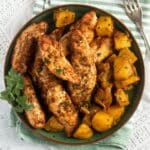 air fryer frozen chicken tenderloins on a plate with potatoes, a fork beside it.