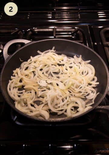 raw onions slices in a frying pan before starting to cook them.