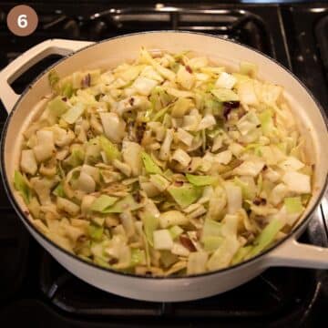 sauteing chopped cabbage in a dutch oven.
