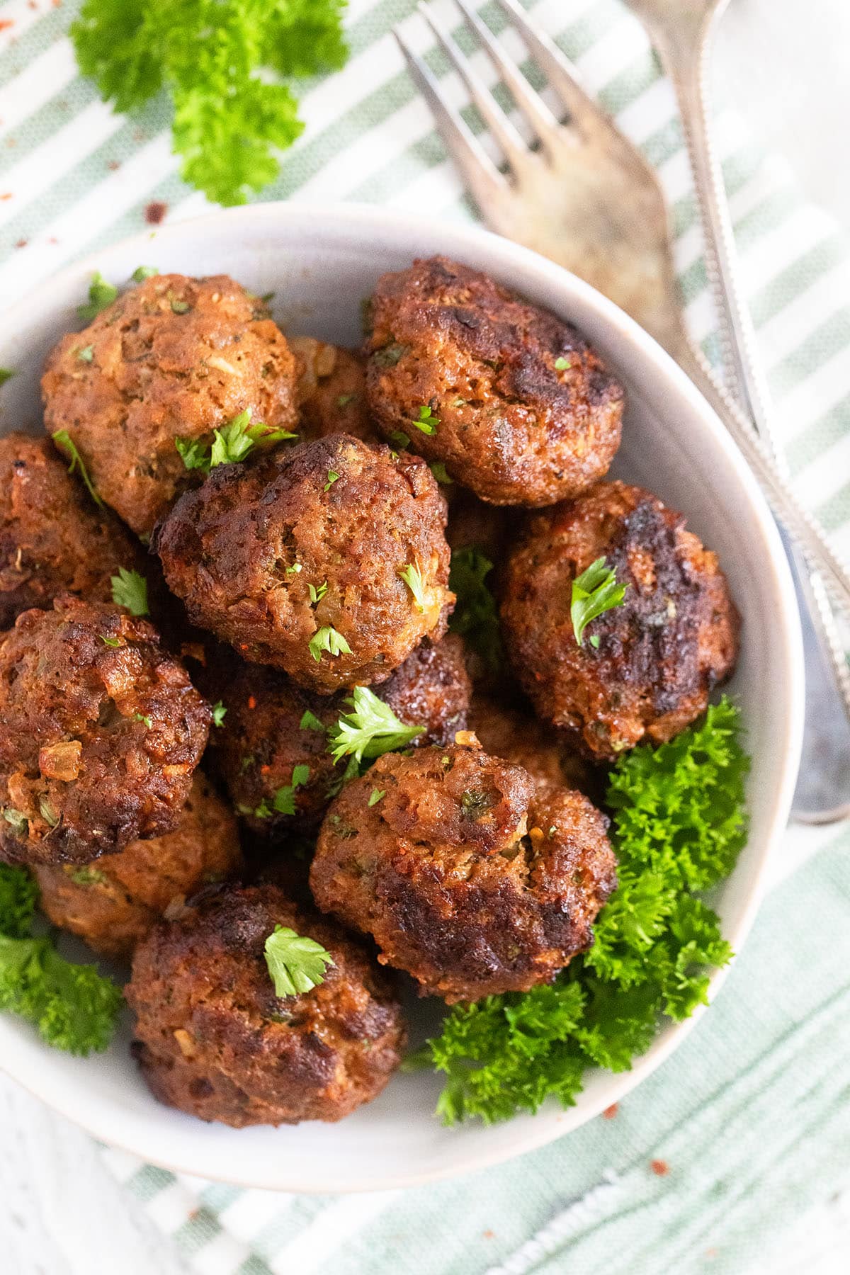 eggless meatballs with parsley in a small bowl.