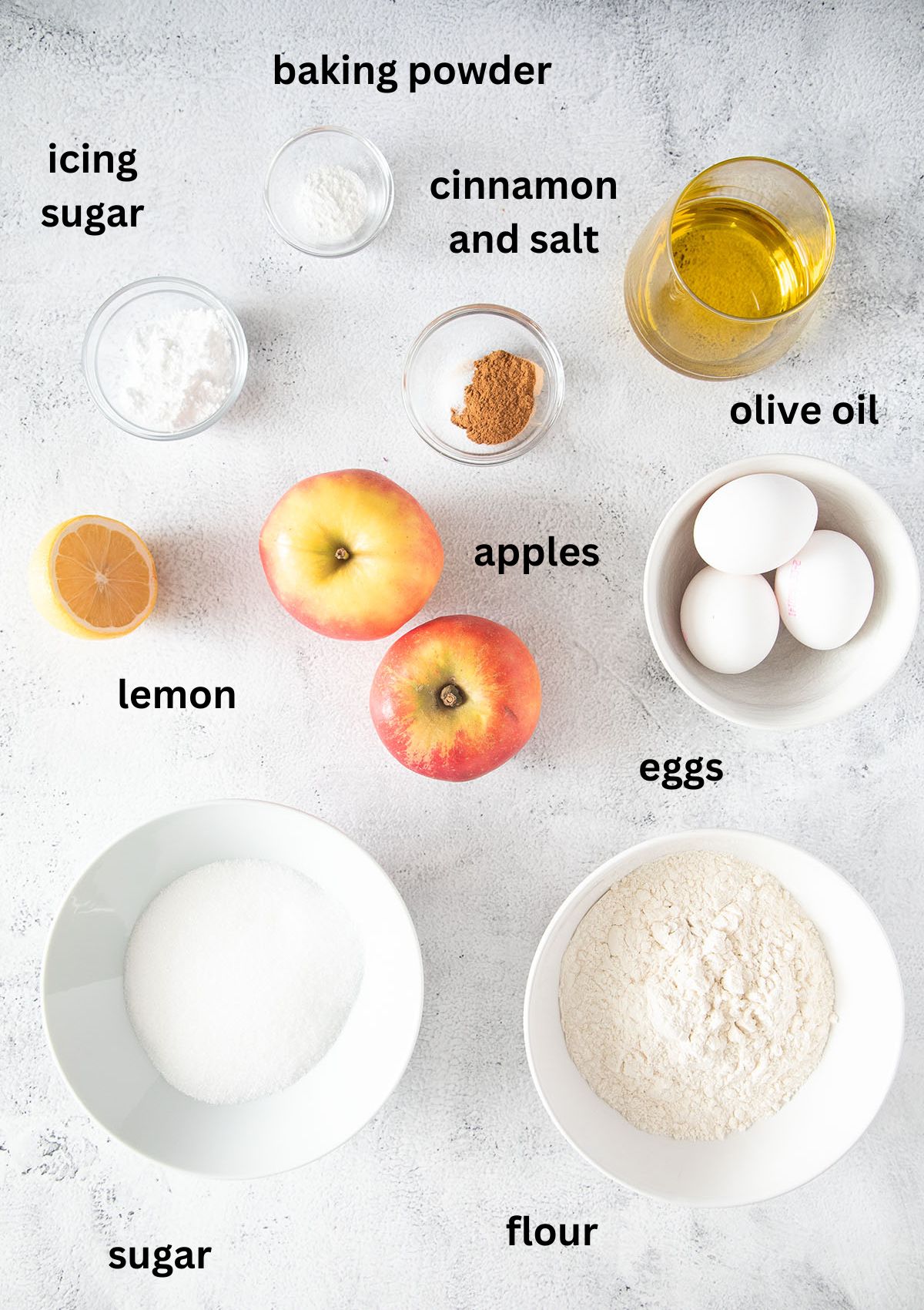 labeled ingredients for apple cake with olive oil and cinnamon.