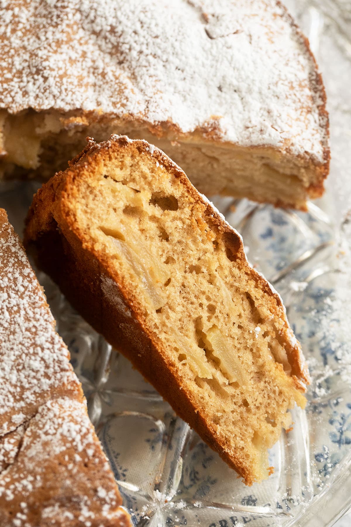 a thick slice of cake with apples showing the crumb.