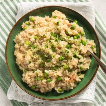 bacon and pea risotto on a small green plate.