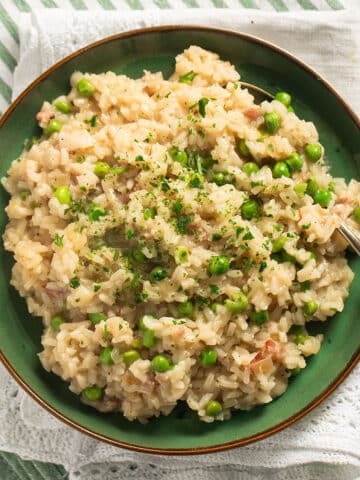 bacon and pea risotto on a small green plate.