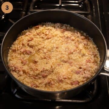 bubbling off white wine in risotto in a saucepan.