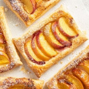 peach puff pastry with sliced fruit pieces and honey drizzle.