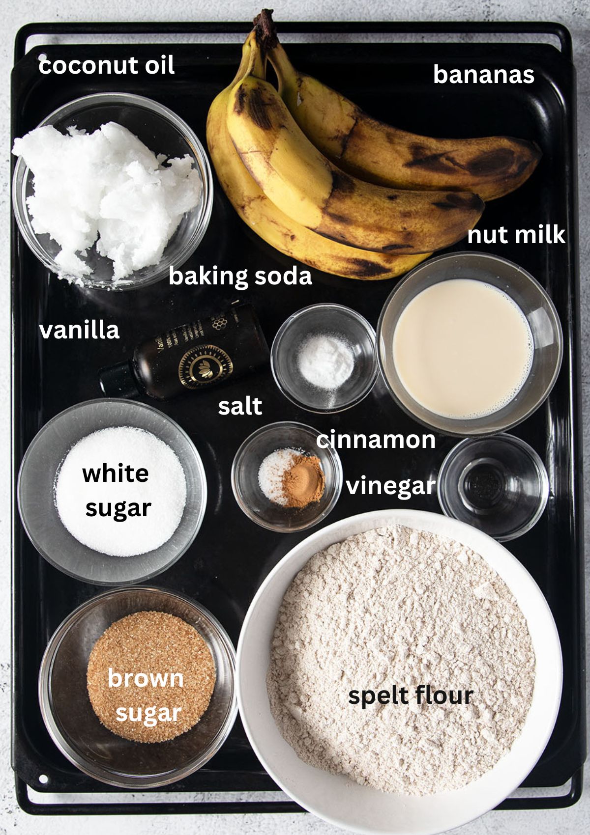 labeled ingredients for making banana bread with spelt flour.