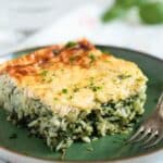 a piece of spinach rice casserole on a green plate.