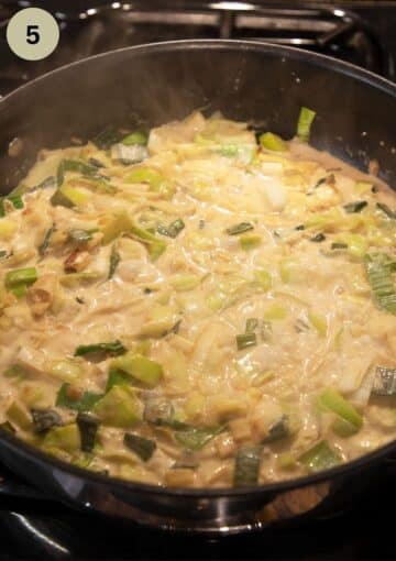 adding heavy cream to a pot with chicken and leeks.