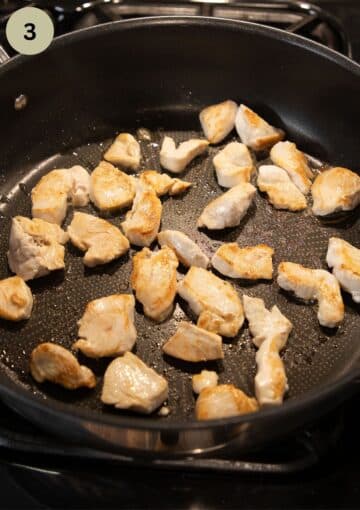 searing chicken breast pieces in a pan.