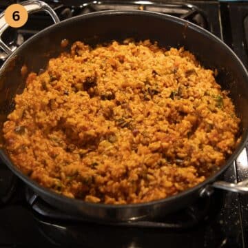 mixed rice with tomato sauce and eggplants in a saucepan.