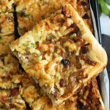 a slice of german onion cake with caramelized onions and bacon.