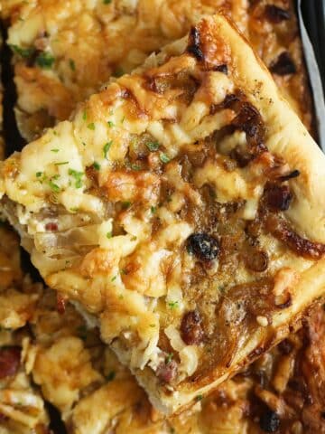 a slice of german onion cake with caramelized onions and bacon.