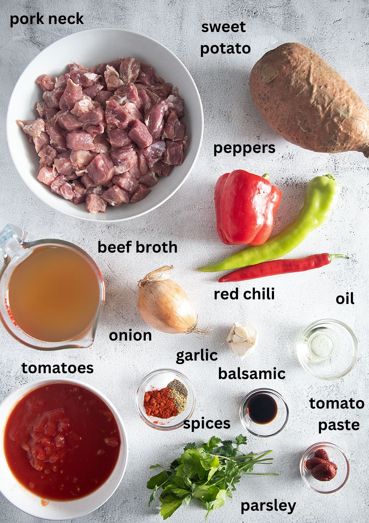 labeled ingredients for making a pork stew with sweet potato, tomatoes, broth, and peppers.