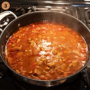 simmering pork cubes in a large pot.