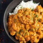 creamy chicken tandoori curry served over basmati rice in a bowl.