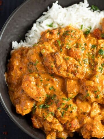 creamy chicken tandoori curry served over basmati rice in a bowl.