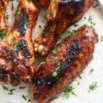 baked bbq turkey wings sprinkled with parsley.