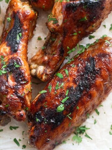 baked bbq turkey wings sprinkled with parsley.