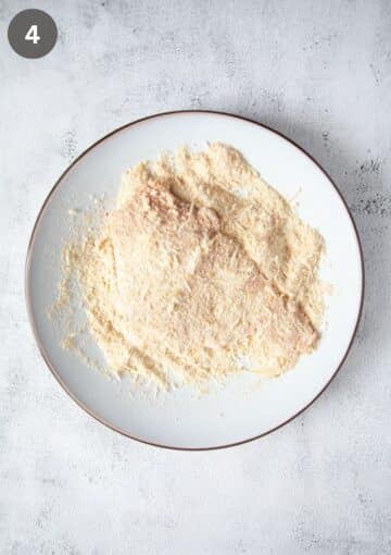 breading turkey pieces with breadcrumbs to make schnitzel.