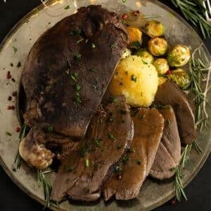 sliced venison roast served with potato dumpling, brussels sprouts and gravy.