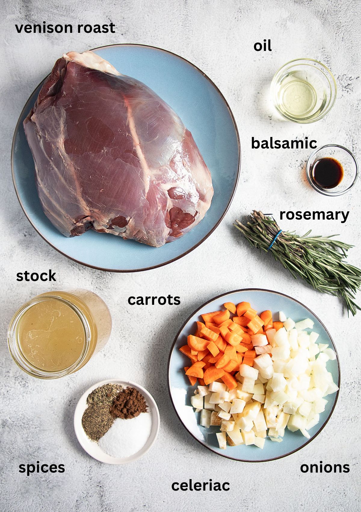 labeled ingredients for cooking a game meat roast with deer, vegetables, broth and rosemary.