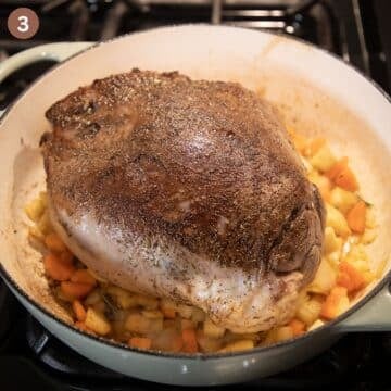 searing deer roast and chopped vegetables in a large dutch oven.