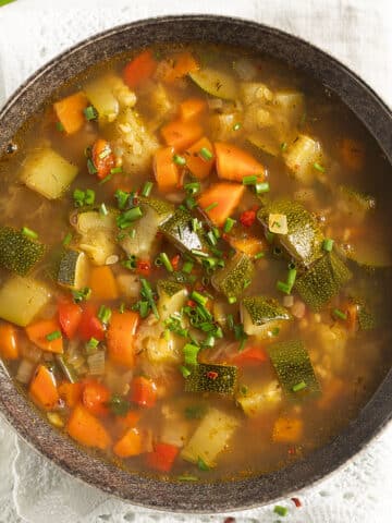 freekeh soup with lots of vegetables in a bowl.