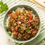 ground turkey teriyaki rice bowl on a striped kitchen towel.