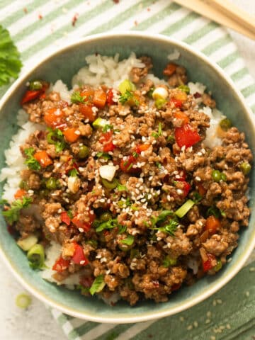 ground turkey teriyaki rice bowl on a striped kitchen towel.