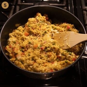 stirring cheese with a wooden spoon into millet.