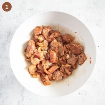 marinating chicken pieces in a large bowl.