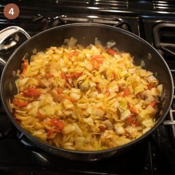 sauteing cabbage, onions and peppers in a large pan.