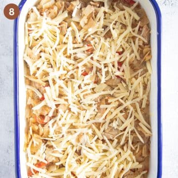 unbaked cabbage and chicken cassserole sprinkled with grated cheese.