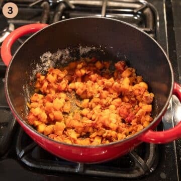 mixing chopped carrots and onions with flour and tomato paste in a soup pot.